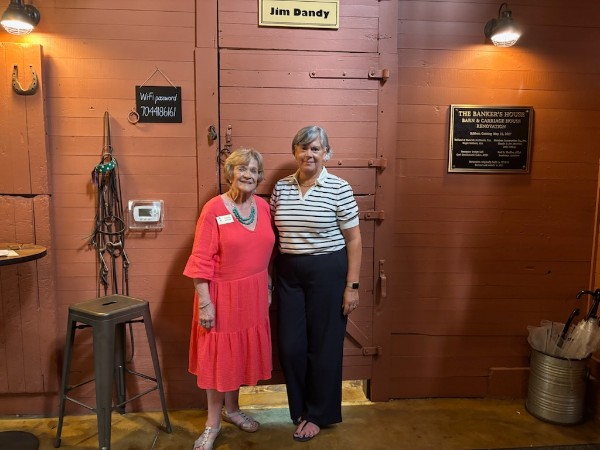 Former Executive Director Carolyn Jackson stands beside new Executive Director May Reed